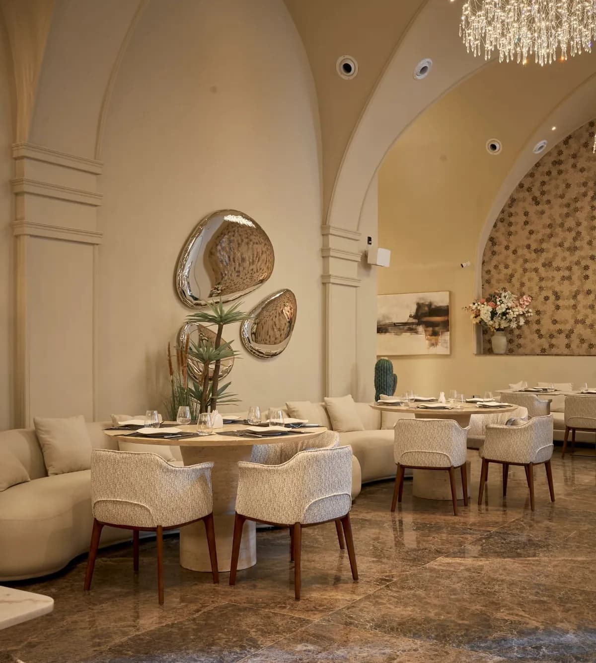 The Havana dining room — sculpted mirrors, curved banquettes, and a crystal chandelier