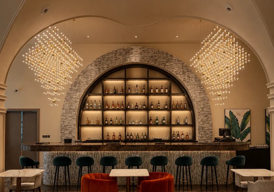 The Havana bar — an illuminated arched spirits display flanked by gold chandeliers